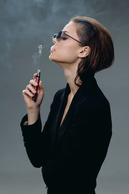 stylish woman smoking vape with sunglasses in black outfit, modern, confident, smoke, minimalistic