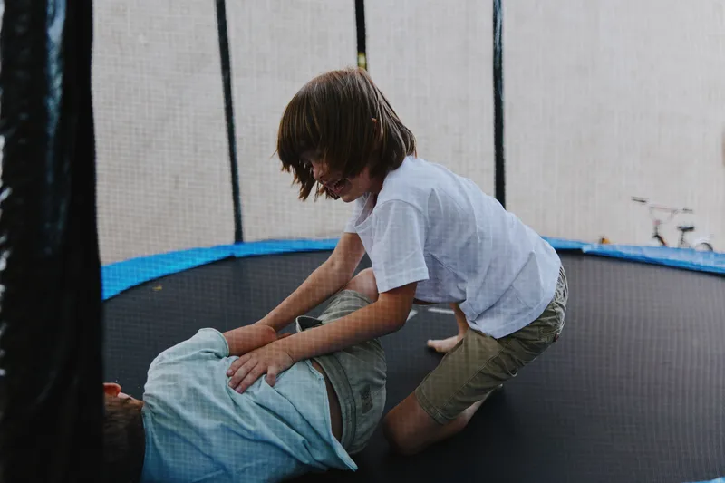 Playful children having fun on a trampoline, showcasing joy and excitement in a vibrant outdoor setting. Perfect for capturing childhood moments.