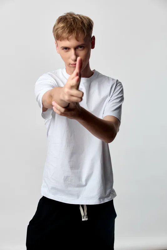 Hands, gesture, pointing, forward, confident, youth, studio, action, focus, motivation in a dynamic pose for communication and motivation in a studio setting