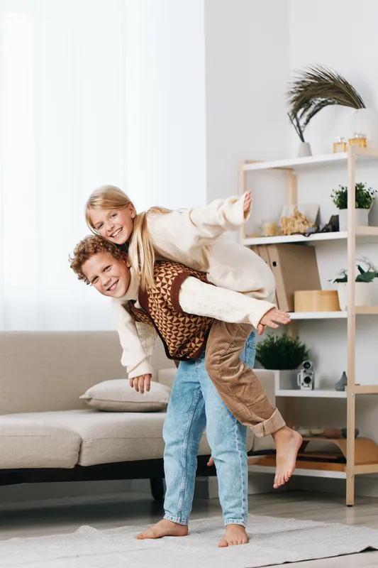 Authentic playful lifestyle scene featuring kids enjoying a school themed game at home, a joyful moment of teamwork, imagination, and friendly pretend play.