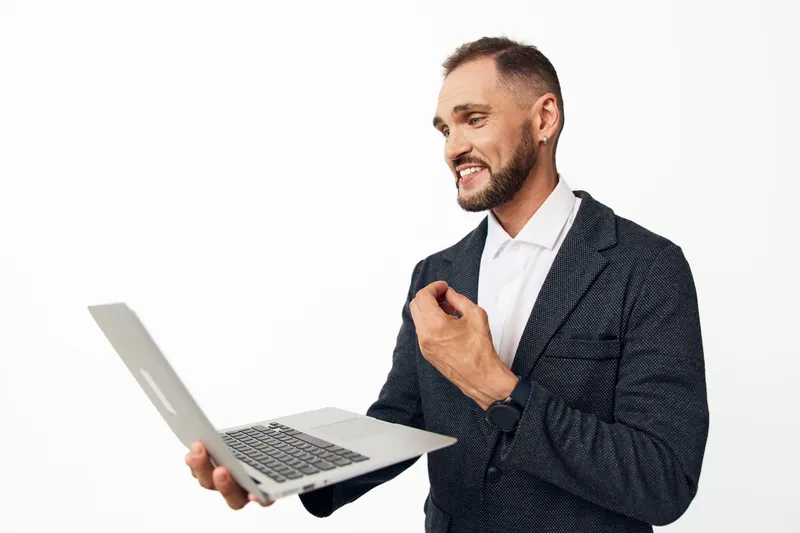 Professional man with a laptop, exuding confidence and optimism, as he presents ideas on a clean, isolated background, ready for business storytelling and corporate campaigns.
