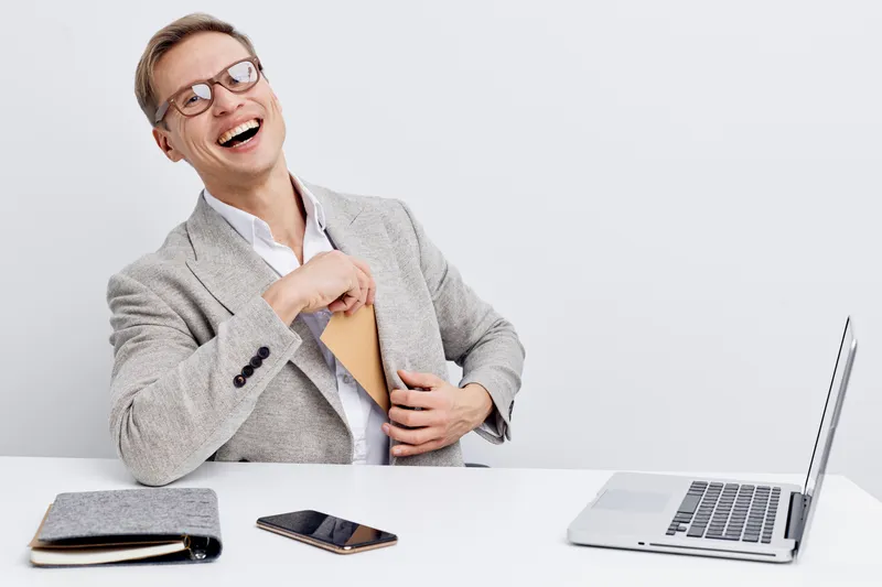 happy man using smartphone laughing cheerful in casual suit with laptop on white background digital nomad cybersecurity concept