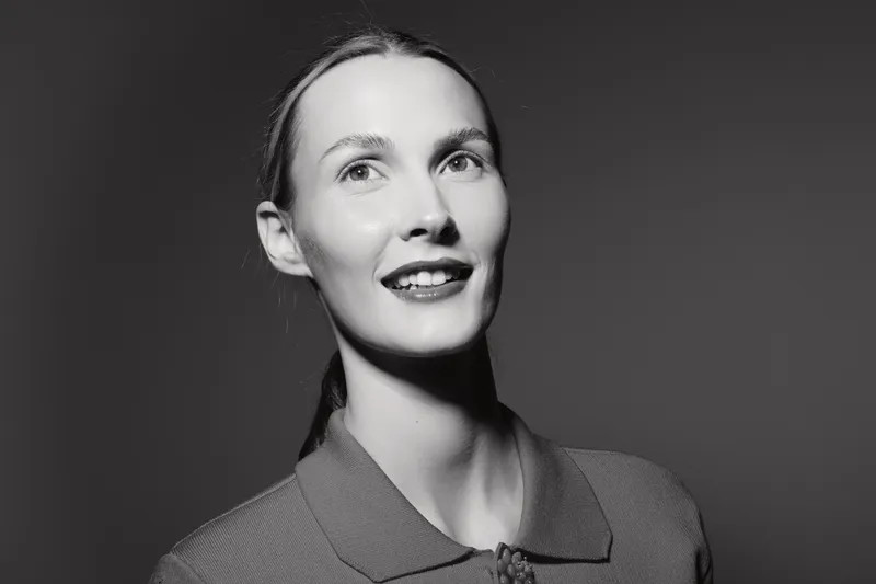 Portrait of a smiling Caucasian woman with light skin in black and white studio lighting. Concept for beauty and positive emotions.