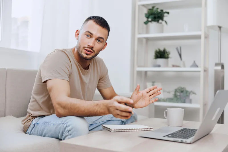 Engaging man communicating ideas in a modern workspace, showcasing creativity and determination. Perfect for themes of remote work and personal growth.