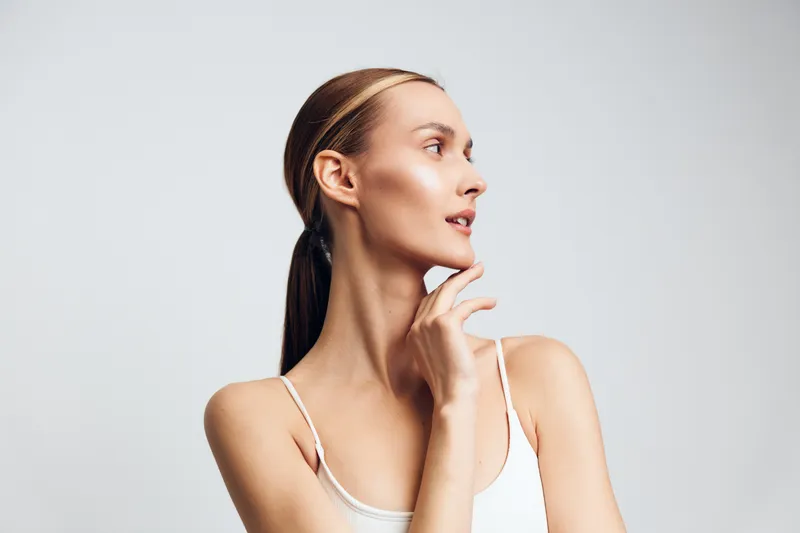 Woman, skincare, self, care, studio, close up, profile, chin, thoughtful expression, soft studio lighting, minimal background, calm mood, beauty focus