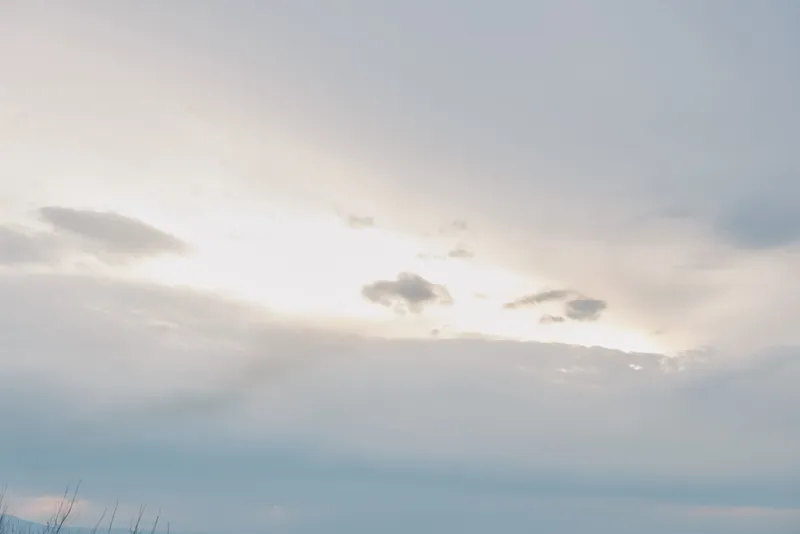 Calm morning sky with soft clouds and light breaking through. Peaceful natural scene with subtle colors and gentle atmosphere, perfect for backgrounds, relaxation, and weather concepts.