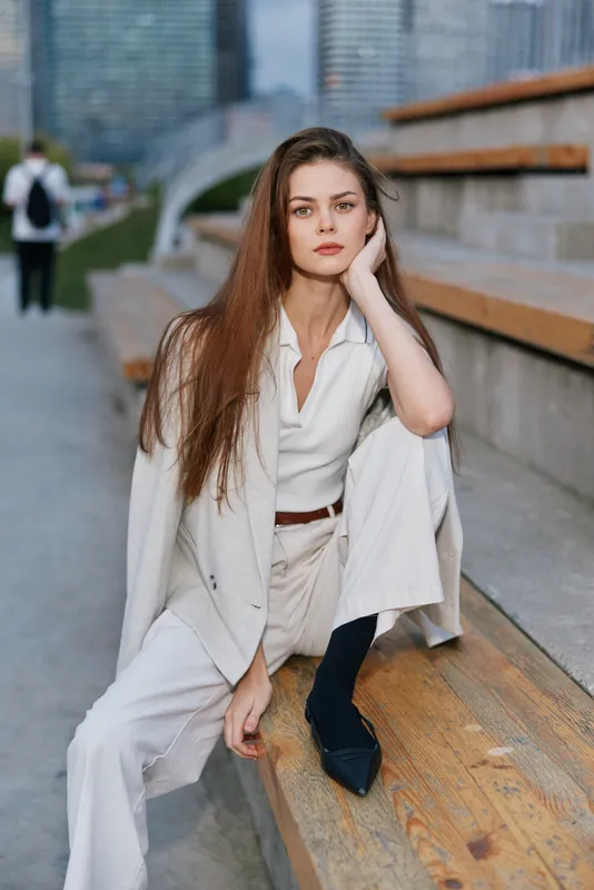 Confident businesswoman in stylish suit showcasing professionalism and elegance in an urban setting, exuding determination and style.