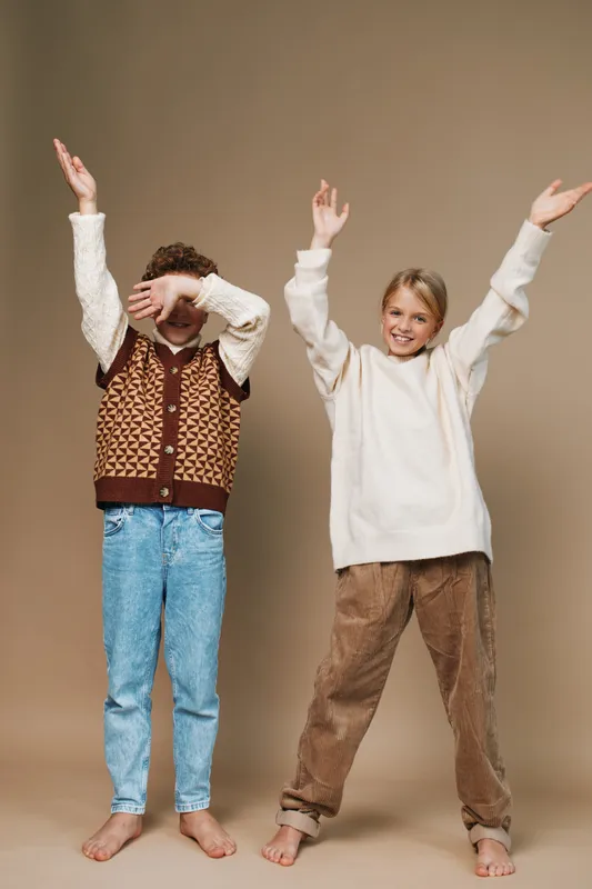 Authentic portrayal of children in a school lifestyle scene, capturing joyful play, natural movement, and casual wardrobe that reflects real life energy and creativity.