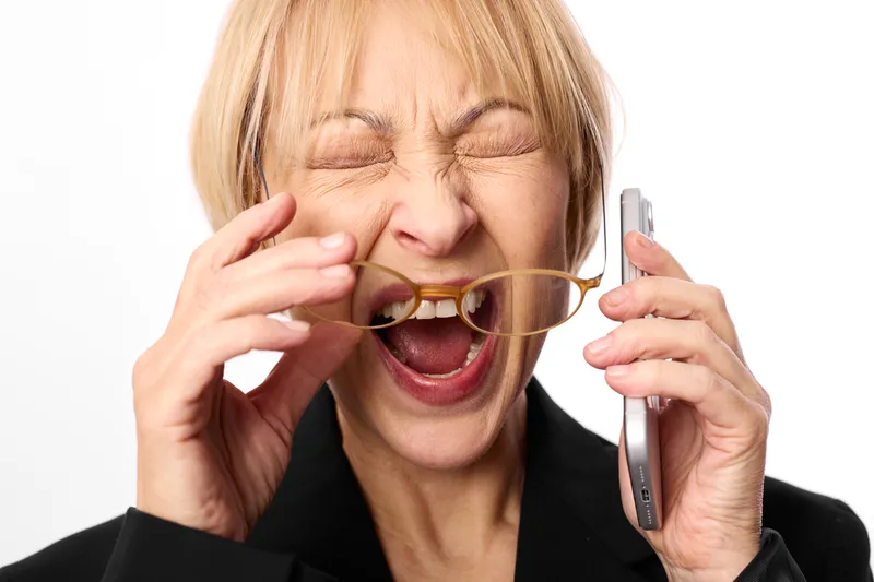 woman business stress laughter, holding razor and shaver near mouth, comedic portrait with eyewear in hand, eyes closed, isolated white background, closeup