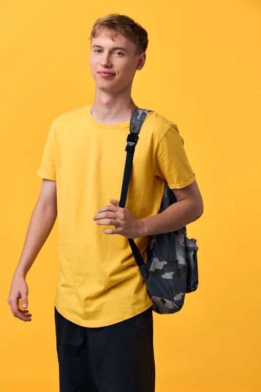 Student youth casual backpack fashion yellow wardrobe male streetwear lifestyle education energy expression ready for daily tasks with confidence in a bright urban setting