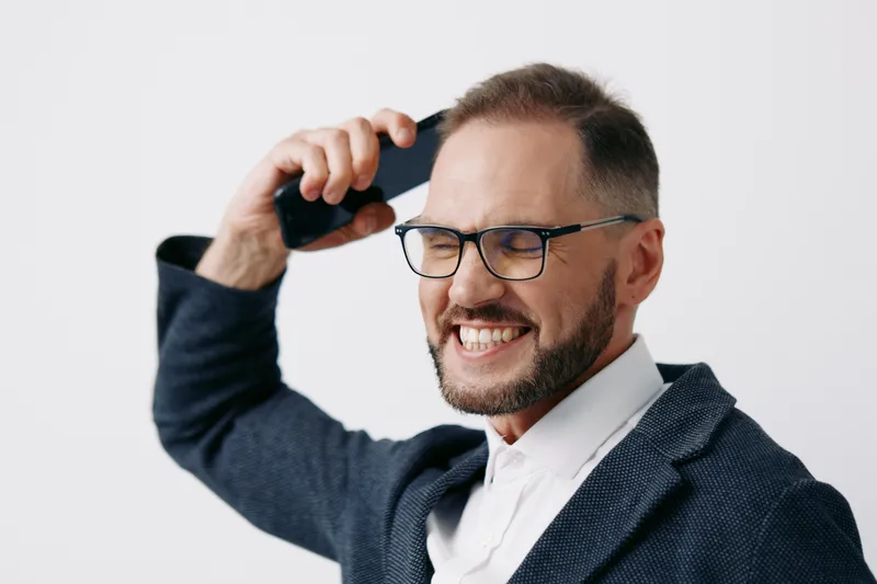 Professional business man on a call, smiling with confidence in a sharp blazer. The isolated colored background enhances his executive presence and energetic focus for corporate use.