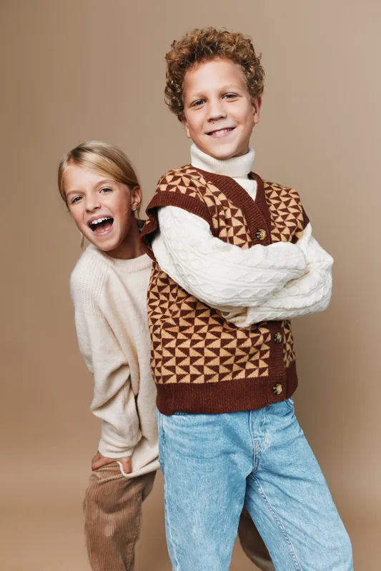 Authentic school life scene showing playful children in casual outfits, engaged in a friendly game, capturing a warm lifestyle moment of everyday youth.