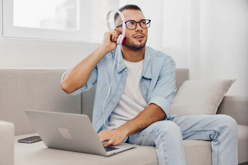 Thoughtful man using laptop, experiencing digital detox, balancing work and life amidst technology stress, embracing authentic imperfection and self-care.