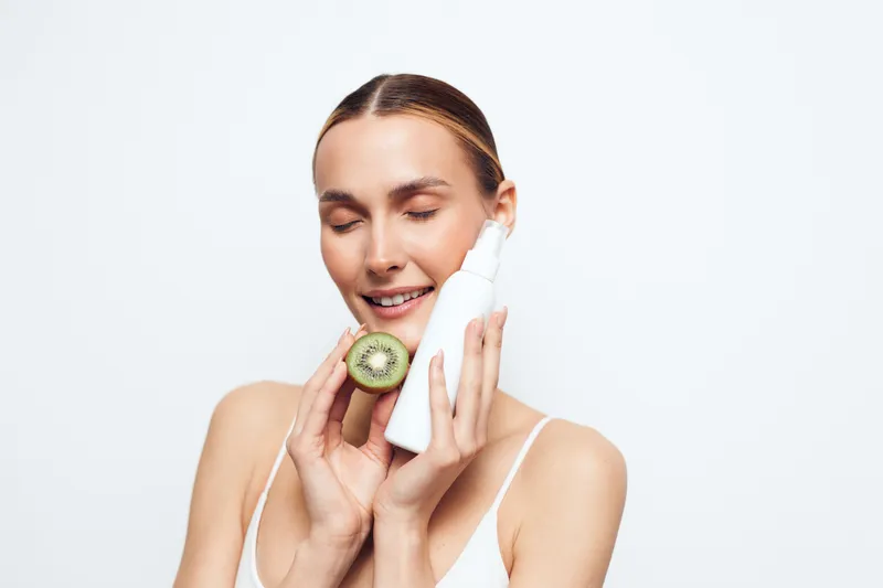 Woman skincare face cleansing beauty spa selfcare wellness, close up of smiling woman using cotton pad and skincare tool, white background, soft studio lighting, gentle hygiene routine