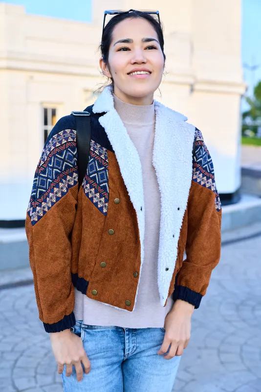 Jacket, sweater, jeans, outdoor fashion, casual street style, confident ensemble in urban setting with knitwear and patterned cardigan, sunny day, relaxed mood, contemporary look