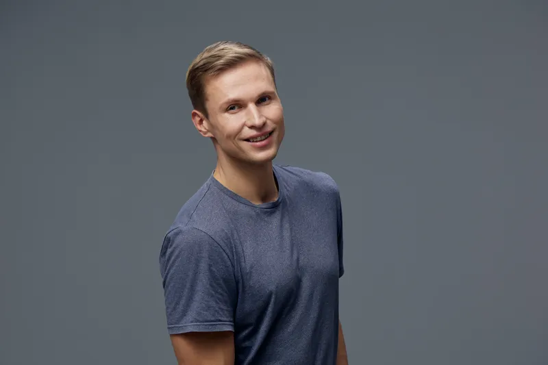 Smiling man casual wear look camera short haircut standing dark gray background digital nomad lifestyle concept