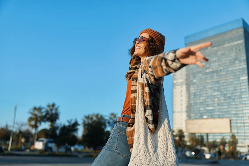 woman joy urban candid lifestyle authenticity golden relaxed fashion freedom enjoying golden hour glow at city street, mindful living and emotional storytelling captured in a spontaneous carefree