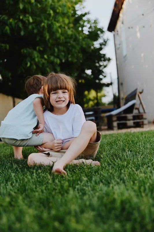 A happy child enjoying a sunny day in the garden, surrounded by greenery. The child’s joyful expression captures the essence of childhood and playfulness. ### ???????? ??????? ???????? (DESCRIPTION2):