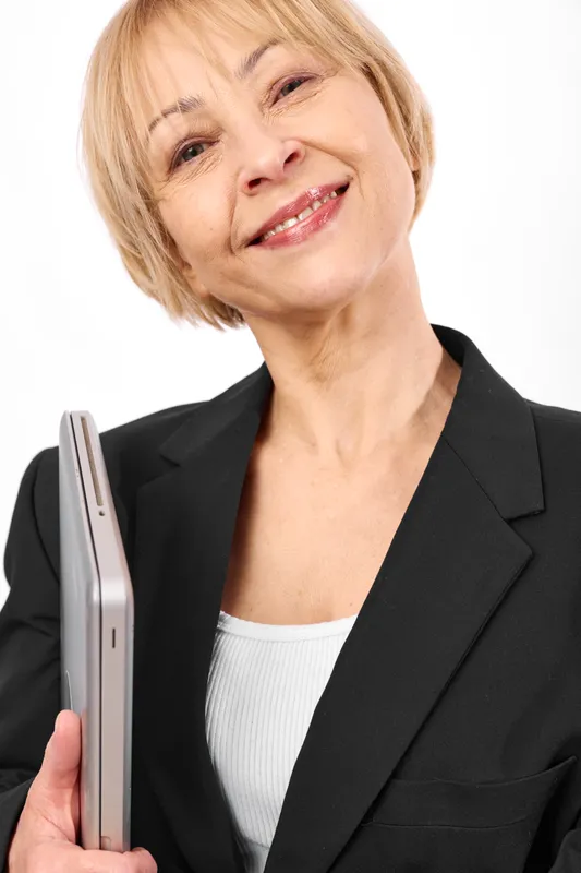 Smiling woman with short blonde hair holds a beauty device for grooming, studio white background, close portrait with soft light, concept of personal care and technology