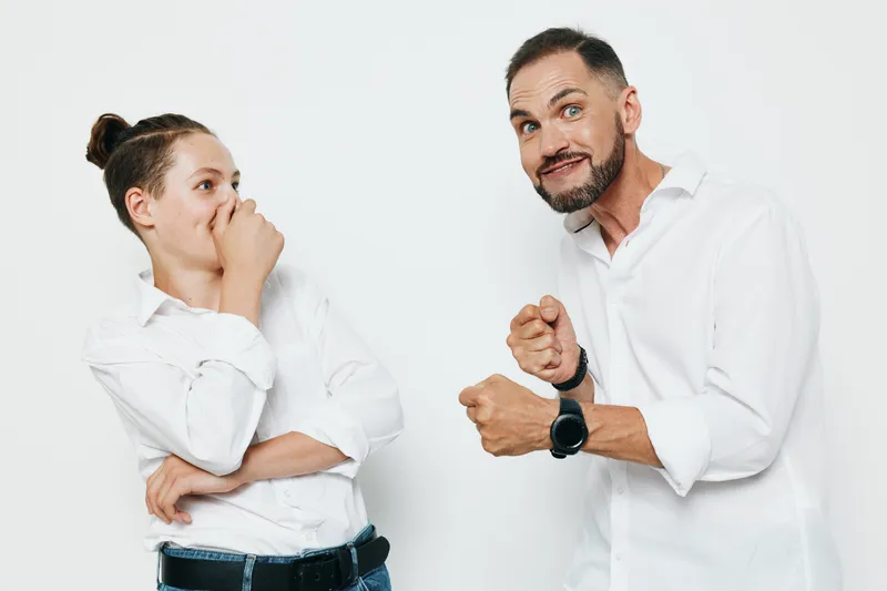 Professional man in a white shirt projects confidence and focus against an isolated colored background, portraying ambition, drive, and readiness for a business challenge.