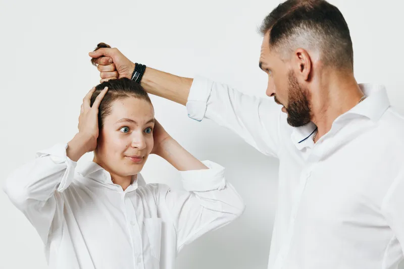 A professional male executive demonstrates confidence and focus in a business setting, performing a poised gesture. Isolated colored background enhances emotional intensity and clarity.