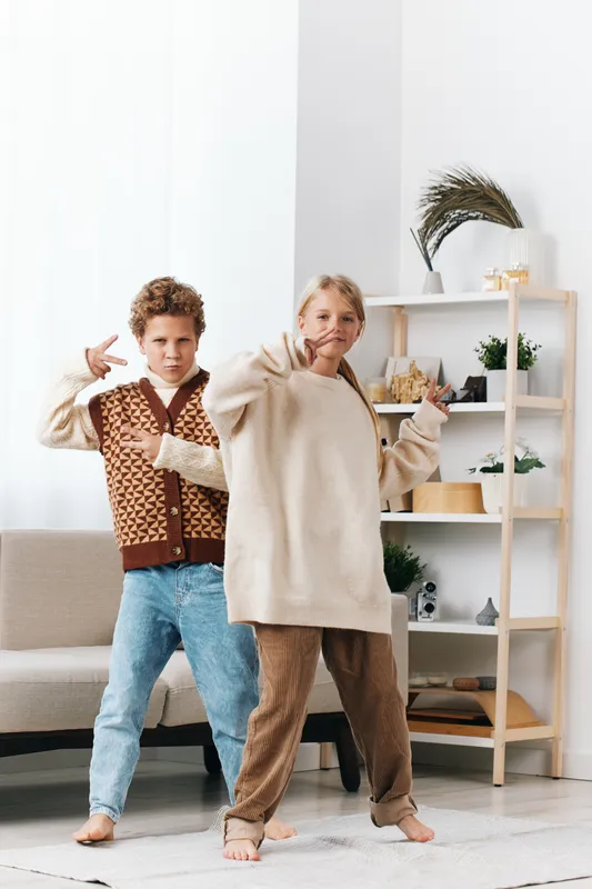 Authentic scene of playful youngsters in a cozy home, capturing a school themed lifestyle moment with spontaneous pose and bright, candid energy.