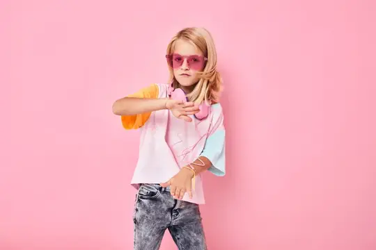 Модная девушка в очках с blond-волосами на розовом фоне
