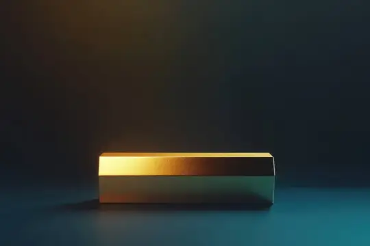 Гладкий золотистый прямоугольный предмет покоится на темно-синем фоне, вызывая ощущение роскоши и изысканности