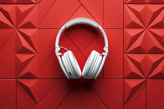 Белые наушники на красной стене с геометрическими фигурами на заднем плане, создающими современную и яркую эстетику