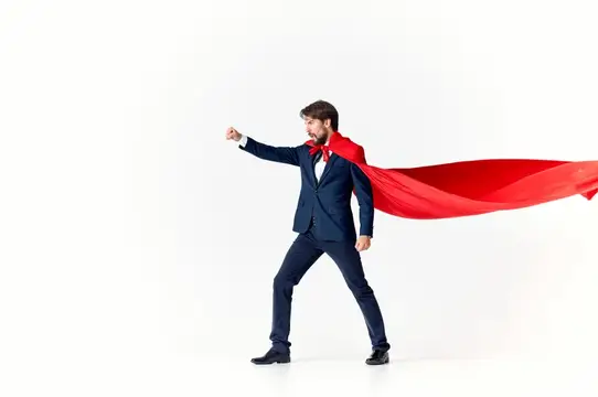 Мужчина в деловом костюме с красной накидкой супергероя