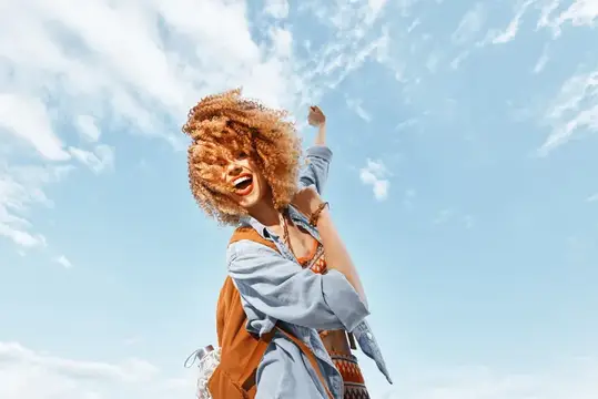 Улыбающаяся женщина танцует с открытым ртом