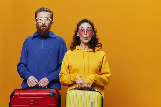Женщина и мужчина улыбаются, в руках у них чемоданы — жёлтый и красный, они весело и задорно улыбаются на жёлтом фоне