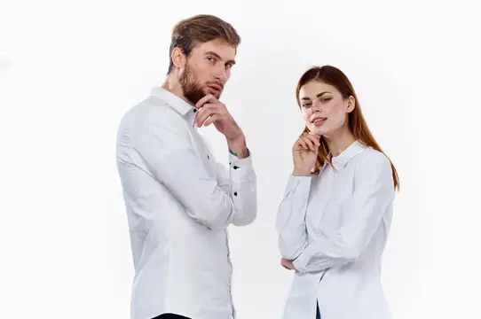 Друзья, семья: мужчина и женщина в одинаковых рубашках на светлом фоне