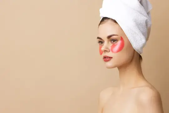 Молодая женщина с патчами для лица, крупный план, веселая атмосфера, уход за кожей и образ жизни