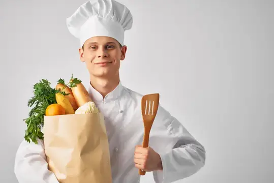 Шеф-повар с упаковкой свежих продуктов занимается приготовлением еды