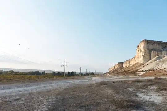 Белые скалы над грунтовой дорогой в ясный день
