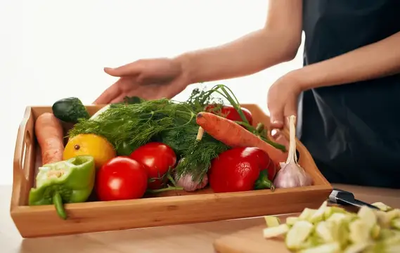 Свежие овощи и зелень в деревянном ящике на кухне