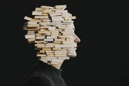 Профиль девушки из стопок книг на чёрном фоне