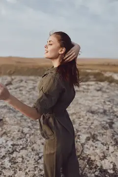 Молодая женщина с закрытыми глазами на каменистом поле