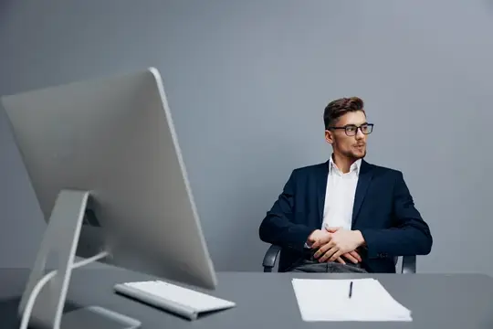 Менеджер в очках с документами на столе за работой