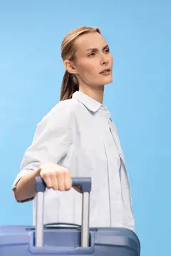 Блондинка с чемоданом на голубом фоне