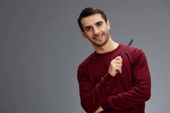Улыбающийся темноволосый мужчина с указкой на сером фоне