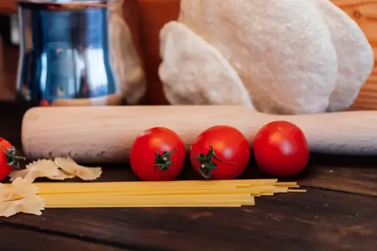 Приготовление итальянской кухни: мука и продукты на кухонном столе