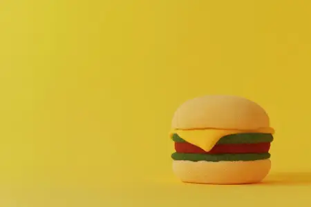 Игривая иллюстрация чизбургера с яркими цветами на желтом фоне, подчеркивающая веселье, еду и креативность