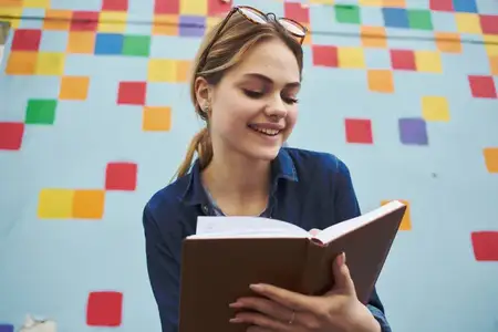 Симпатичная женщина на улице с книгой в руках, свежий воздух, образ жизни