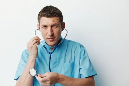 Привлекательный молодой мужчина-хирург в медицинской форме со стетоскопом