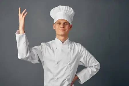 Эмоциональный шеф-повар-мужчина жестикулирует рукой в ресторане, профессиональная работа