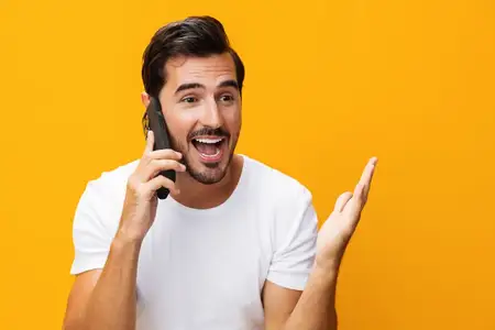 Улыбающийся мужчина, выражающий радостное удивление, позирует в студии на изолированном фоне