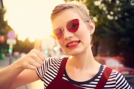 Женщина в солнцезащитных очках позирует на улице, игра, мода и романтика