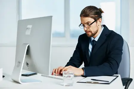 Бизнесмен работает за компьютером с документами